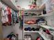 Closet with built-in storage shelves for clothes, shoes, and toys to maximize organization at 6095 Fords Nw Rd, Acworth, GA 30101
