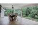 Spacious dining area with large glass windows offering a serene view of lush backyard and pool at 6095 Fords Nw Rd, Acworth, GA 30101