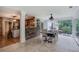 Light filled dining room adjacent to kitchen featuring stone accent wall and backyard pool view at 6095 Fords Nw Rd, Acworth, GA 30101