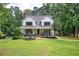 Charming two-story home with a welcoming front porch and beautifully landscaped front yard at 6095 Fords Nw Rd, Acworth, GA 30101