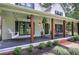 Covered front porch featuring a swing and rocking chairs, perfect for enjoying the outdoors at 6095 Fords Nw Rd, Acworth, GA 30101
