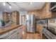 Kitchen featuring stainless steel appliances, wood cabinets, island and hardwood floors at 6095 Fords Nw Rd, Acworth, GA 30101