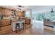 Kitchen with stainless steel appliances, wood cabinets, island and view of the den at 6095 Fords Nw Rd, Acworth, GA 30101