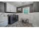 Charming laundry room with modern washer/dryer, stylish floor tiles, and built in storage at 6095 Fords Nw Rd, Acworth, GA 30101