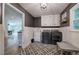 Laundry room with modern appliances, stylish floors and access to rest of the house at 6095 Fords Nw Rd, Acworth, GA 30101