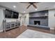 Hardwood floors accentuate a spacious living room with brick fireplace and media cabinet at 6095 Fords Nw Rd, Acworth, GA 30101