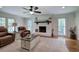 Cozy living room with a white brick fireplace, hardwood floors and comfortable leather chairs at 6095 Fords Nw Rd, Acworth, GA 30101