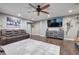 Relaxing living room featuring hardwood floors, media console, and comfortable brown couches at 6095 Fords Nw Rd, Acworth, GA 30101