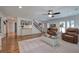 Spacious living room with hardwood floors, staircase, and comfortable leather chairs at 6095 Fords Nw Rd, Acworth, GA 30101