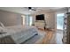 Cozy primary bedroom boasts hardwood floors, neutral walls, and outdoor access at 6095 Fords Nw Rd, Acworth, GA 30101