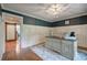 Bright office space with hardwood floors, a custom desk, wainscoting, and a sliding barn door at 6095 Fords Nw Rd, Acworth, GA 30101