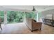 Sunroom featuring large windows with backyard views, fan, and a neutral color palate at 6095 Fords Nw Rd, Acworth, GA 30101