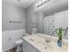 Bathroom featuring neutral walls, a vanity with a sink, and a toilet at 859 Scales Rd, Suwanee, GA 30024