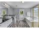 Bright bathroom featuring double vanity, soaking tub, and a glass-enclosed shower at 859 Scales Rd, Suwanee, GA 30024