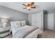 Bedroom with closet, ceiling fan, neutral walls, and a side table with lamp at 859 Scales Rd, Suwanee, GA 30024