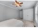 Bedroom with ceiling fan, carpet, a bed, and two closets at 859 Scales Rd, Suwanee, GA 30024