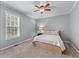 Cozy bedroom with carpet flooring, a ceiling fan, a bed, and a window at 859 Scales Rd, Suwanee, GA 30024