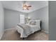 Cozy bedroom with neutral walls, carpet flooring, ceiling fan, and a window at 859 Scales Rd, Suwanee, GA 30024