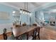 Open floor plan showcasing the dining room flowing into the living room with hardwood floors and natural light at 859 Scales Rd, Suwanee, GA 30024