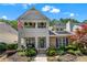 Charming two-story home with stone accents, a cozy porch, and a landscaped front yard at 859 Scales Rd, Suwanee, GA 30024
