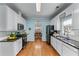 Updated kitchen featuring white cabinets, stainless steel appliances, granite countertops, and hardwood floors at 859 Scales Rd, Suwanee, GA 30024