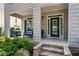 Inviting front porch with stone steps and a comfortable seating area at 859 Scales Rd, Suwanee, GA 30024