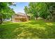Large, well-maintained backyard with a spacious lawn, wooden deck, and mature trees at 115 Bennett Farms Dr, Acworth, GA 30102