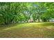 An expansive green lawn provides ample space in this wooded backyard at 115 Bennett Farms Dr, Acworth, GA 30102