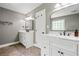 Bathroom featuring dual vanities, marble countertops, and decorative lighting at 115 Bennett Farms Dr, Acworth, GA 30102