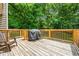 Outdoor wooden deck area with wooded view, perfect for grilling and entertaining at 115 Bennett Farms Dr, Acworth, GA 30102