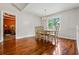 Dining room with hardwood floors, natural light, and adjacent bedroom view at 115 Bennett Farms Dr, Acworth, GA 30102