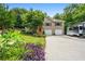 Charming home with a two-car garage, a well-maintained front yard, and a colorful garden at 115 Bennett Farms Dr, Acworth, GA 30102