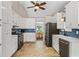 Spacious kitchen with white cabinets, stainless steel appliances, and a connected dining area at 115 Bennett Farms Dr, Acworth, GA 30102