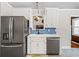 Modern kitchen with stainless steel appliances, white cabinets, and eat-in area at 115 Bennett Farms Dr, Acworth, GA 30102