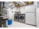 The laundry area in the basement features a washer and dryer and a refrigerator at 115 Bennett Farms Dr, Acworth, GA 30102