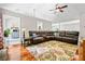 Spacious living room featuring hardwood floors, vaulted ceiling and oversized sectional sofa at 115 Bennett Farms Dr, Acworth, GA 30102