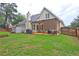 Backyard view showcasing a well-maintained lawn, charming patio with pergola, and a privacy fence at 2230 Laurel Lake Dr, Suwanee, GA 30024