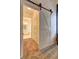Bathroom view featuring sliding barn door access and adjacent bathtub at 2230 Laurel Lake Dr, Suwanee, GA 30024