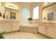 Bright bathroom featuring dual vanities, soaking tub, and tiled flooring at 2230 Laurel Lake Dr, Suwanee, GA 30024