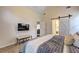 Bedroom with sliding barn door, vaulted ceiling, and cozy carpet at 2230 Laurel Lake Dr, Suwanee, GA 30024