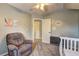 Bright Bedroom features a recliner, changing table and fun artwork at 2230 Laurel Lake Dr, Suwanee, GA 30024