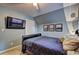 Cozy bedroom with wall-mounted TV and natural light at 2230 Laurel Lake Dr, Suwanee, GA 30024