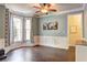Light-filled dining room featuring elegant wood flooring and wainscoting and crown moulding at 2230 Laurel Lake Dr, Suwanee, GA 30024