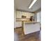Modern kitchen with island, stainless appliances, granite counters, and wood floors at 2230 Laurel Lake Dr, Suwanee, GA 30024