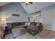 Open living room showcases a large, comfortable sectional and staircase with white painted wood at 2230 Laurel Lake Dr, Suwanee, GA 30024