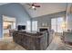 Cozy living room with a fireplace, large sectional sofa, and view into the eat-in kitchen at 2230 Laurel Lake Dr, Suwanee, GA 30024