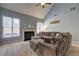 Bright living room featuring a fireplace, large windows, and a plush, oversized sectional sofa at 2230 Laurel Lake Dr, Suwanee, GA 30024