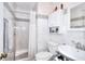 Bathroom featuring tiled walls, a shower with a curtain, a toilet, and a sink with storage at 2573 Mistletoe Ln, Snellville, GA 30039