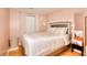 Cozy bedroom with a large bed, hardwood floors, and a vanity area with a lit mirror at 2573 Mistletoe Ln, Snellville, GA 30039