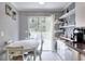 Bright eat-in kitchen with white cabinets, stainless appliances, and a view of the backyard at 2573 Mistletoe Ln, Snellville, GA 30039